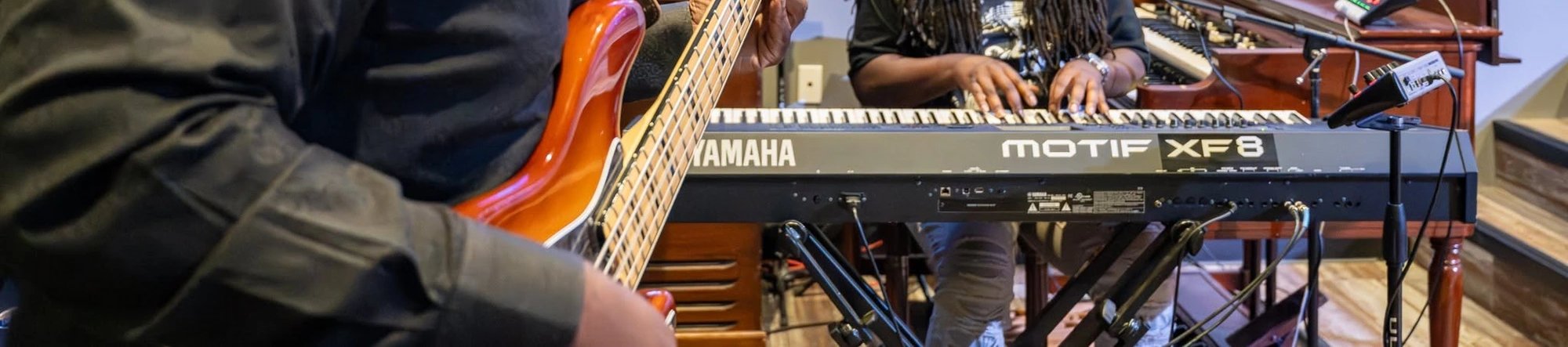 Worship musicians on bass and keys during service